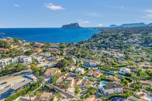 an aerial view of a residential neighborhood with the ocean at Traviata in Cap Blanc
