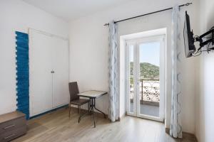 a room with a table and a door to a balcony at Bed And Breakfast Il Ceppo Wild in Pimonte