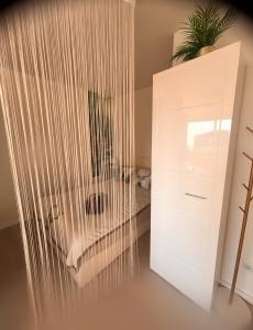 a room with a white cabinet and a chair at Über den Dächern von Aachen in Aachen +10 photos