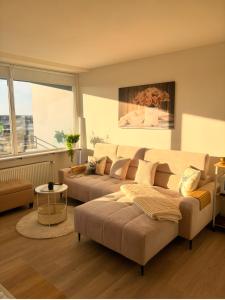 a living room with a couch and a table at Über den Dächern von Aachen in Aachen