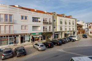 a row of cars parked in a parking lot next to buildings at Oasis de Ferrel in Ferrel