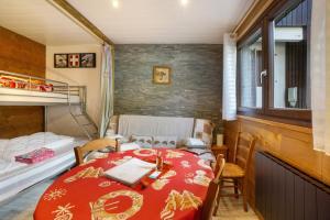 a small room with a table and a bed at Les Airelles 32 in Villarodin-Bourget