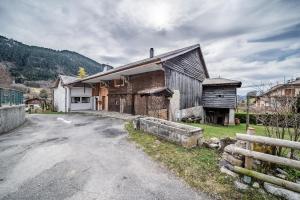an old barn sitting on the side of a road at Le Chat Perché in Bernex