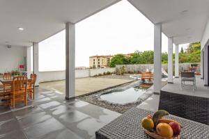 a living room with a bowl of fruit on a table at Paraiso Madeira - Suites in Gaula