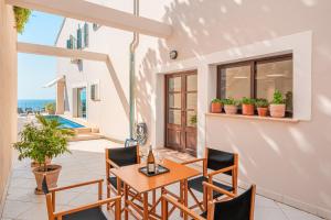 a table and chairs on a patio with a view of the ocean at Casa del Puerto in Port de Soller