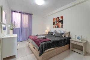 a bedroom with a large bed in a white room at Seaview las Americas in Adeje