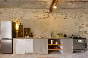 a kitchen with a refrigerator and a stove at Gästehaus Schlamau19 in Schlamau