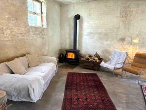 a living room with a couch and a wood stove at Gästehaus Schlamau19 in Schlamau