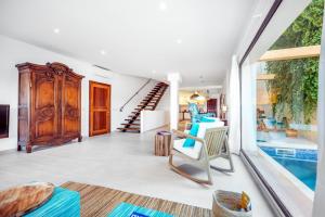 a living room with a large window and a staircase at Casa del Puerto in Port de Soller