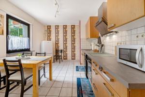 a kitchen with a table and a microwave at Rheinferien in Kamp-Bornhofen