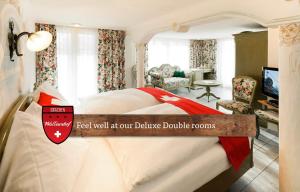 A bed or beds in a room at Hotel Walliserhof - The Dom Collection