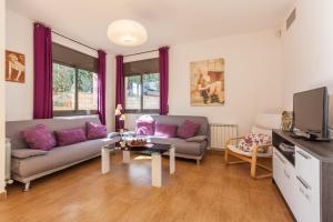 a living room with a couch and a table at Casa Lourdes in Canyelles