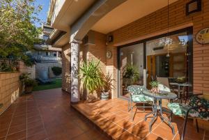 an outdoor patio with a table and chairs at Casa Lourdes in Canyelles