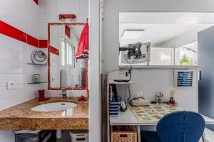 a bathroom with a sink and a mirror at Studio chez Brigitte à Audenge in Audenge +12 photos