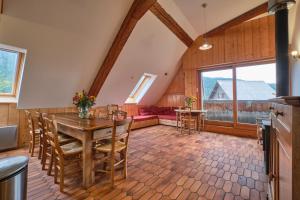 a kitchen and dining room with a table and chairs at Gite Sappey Chartreuse in Le Sappey-en-Chartreuse