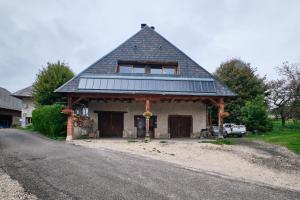 a house with a gambrel roof on the side of a road at Gite Sappey Chartreuse in Le Sappey-en-Chartreuse