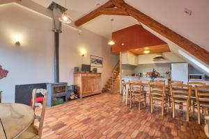 a kitchen and dining room with a table and chairs at Gite Sappey Chartreuse in Le Sappey-en-Chartreuse