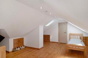 a attic bedroom with a bed and a skylight at Gutshaus am Teich in Neukloster