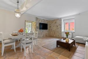 a living room with a table and a couch at La Casuca del Músico in Novales