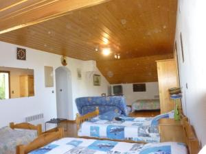 a living room with two beds and a wooden ceiling at Chalet St Victoire - Les Orres in Les Orres