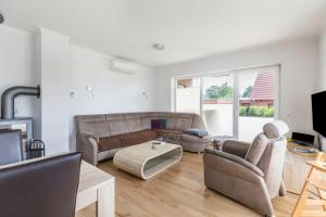 a living room with a couch and two chairs at Ferienhaus Manni Eg in Büsum