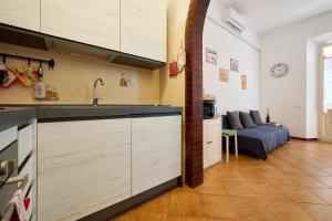a kitchen with a sink and a couch in a room at Casabaffo in Piombino +12 photos