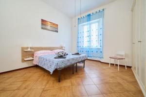 a bedroom with a bed and a table and a window at Casabaffo in Piombino
