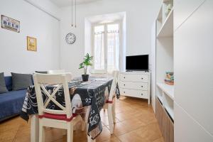a small living room with a table and a tv at Casabaffo in Piombino
