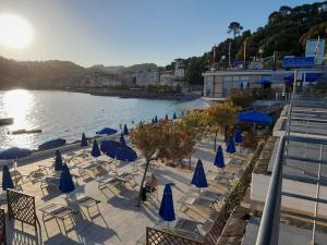 a beach with chairs and umbrellas and a body of water at Casa Vanda - 5 Terre in Arcola