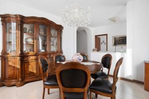 a dining room with a table and chairs and a chandelier at Casa Vanda - 5 Terre in Arcola +36 photos