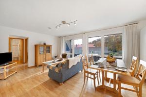a living room with a couch and a dining room table at Pension Deutscher Hof in Oberbiederbach