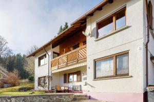 a white house with a deck on the side of it at Haus Wintersonne in Feldberg