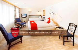 A bed or beds in a room at Hotel Walliserhof - The Dom Collection