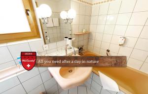 A bathroom at Hotel Walliserhof - The Dom Collection