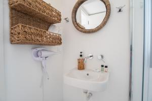 a bathroom with a sink and a mirror at Villa Anastasio in Kampos Paros +45 photos