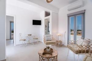 a living room with a couch and chairs and a table at Villa Anastasio in Kampos Paros