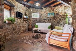 a living room with a stone wall at Casa Rural Abuelo Jose in Robledo de las Traviesas