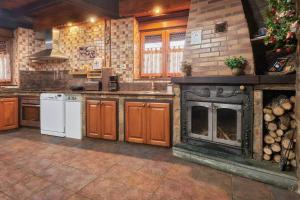 a kitchen with a stove and a fireplace at Casa Rural Abuelo Jose in Robledo de las Traviesas