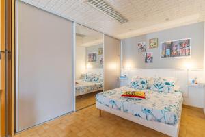 a bedroom with a bed and a large mirror at Les Cerisiers in Apt