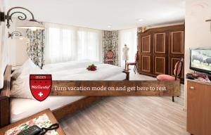A bed or beds in a room at Hotel Walliserhof - The Dom Collection