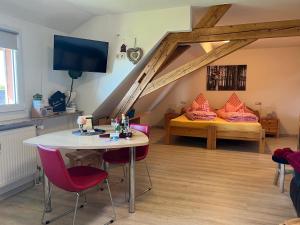 a room with a table and chairs and a bed at Haus Jehle in Görwihl
