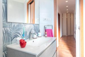 a bathroom with a white sink and a pink towel at Sole e Girasoli in Molfetta +23 photos