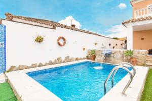 a swimming pool in the backyard of a house at Casa Familiar La Lobita 2 in Conil de la Frontera
