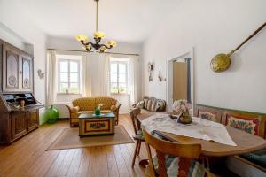 a living room with a table and a couch at Ferienwohnung Abtei Klosterhof in Maring-Noviand