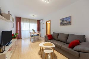 a living room with a couch and a table at Rincon de Almerimar Palm Beach Golf in Almerimar