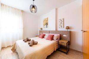 a bedroom with a bed with two towels on it at Rincon de Almerimar Palm Beach Golf in Almerimar +20 photos