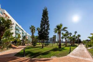 a park with palm trees and a building at Rincon de Almerimar Palm Beach Golf in Almerimar