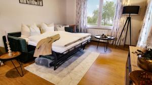 a bedroom with a bed and a couch and a window at Franz Josefs Wald-Chalets in Untergriesbach