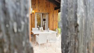 a white table and chairs on a patio at Franz Josefs Wald-Chalets in Untergriesbach