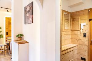 a room with a refrigerator and a wooden wall at Ammerstube Oberammergau in Oberammergau +21 photos